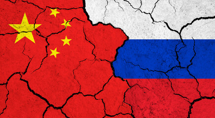 Flags of China and Russia on cracked surface - politics, relationship concept