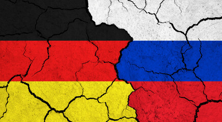 Flags of Germany and Russia on cracked surface - politics, relationship concept