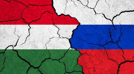 Flags of Hungary and Russia on cracked surface - politics, relationship concept