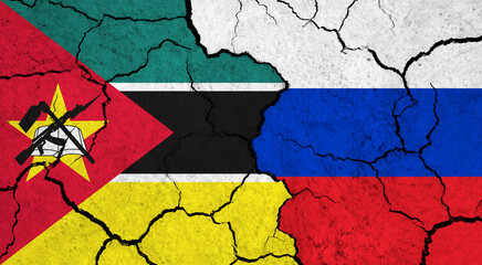 Flags of Mozambique and Russia on cracked surface - politics, relationship concept