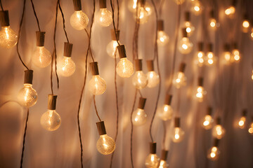 Cosy light bulb fairy lights on a wall.