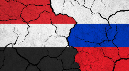 Flags of Yemen and Russia on cracked surface - politics, relationship concept