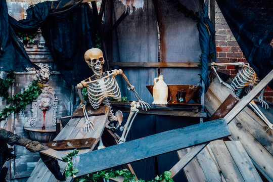 Outdoor Decor for Halloween. skeletons climbing out of the different wooden rubble. Halloween scenery. Terrible holiday photo zone on location for event. Traditions and decorations. Selective focus.