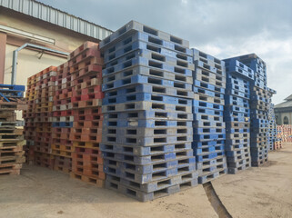 pile of dirty plastic pallets, concept photo of bankruptcy service cargo transportation industry service