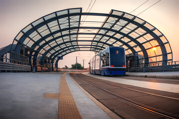 Fototapeta na wymiar Tram on the viaduct during sunrise. Bydgoszcz trams.