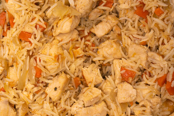 Tasty pilaf with chicken as background.