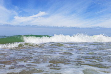 Beautiful tropical beach with blue sky with clouds as abstract nature background. Scenic landscape with sparkling waves ocean, aesthetic beauty nature. Summer day on Baltic sea, Curonian spit.