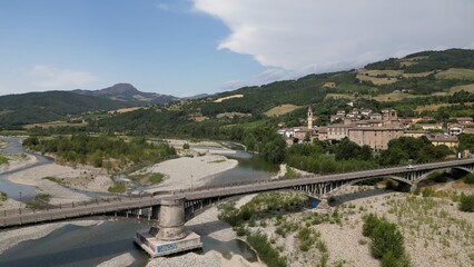 Europe, Italy , Emilia Romagna , drone aerial view of Travo village with bridge on the river in Val Trebbia Bobbio - drought and aridity during summer water emergency - Climate change global warming  