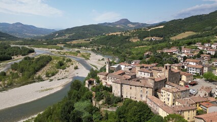 Fototapeta na wymiar Europe, Italy , Emilia Romagna , drone aerial view of Travo village with bridge on the river in Val Trebbia Bobbio - drought and aridity during summer water emergency - Climate change global warming 