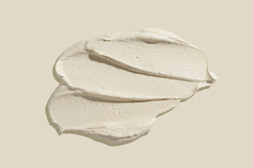 Scrub smear on a beige background. Beauty texture. Sample of a cosmetic product.