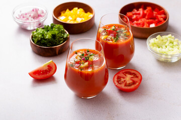 Spanish tomato gazpacho cold soup styled and decorated in glasses