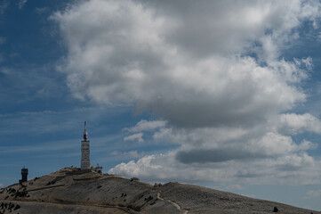 The top of the Mont Ventoux in Vaucluse at 1910m,  with the observation tower and antenna. A cloudy sky.