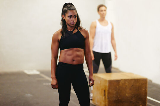 Fit young woman ready for a box jump workout session - Powered by Adobe