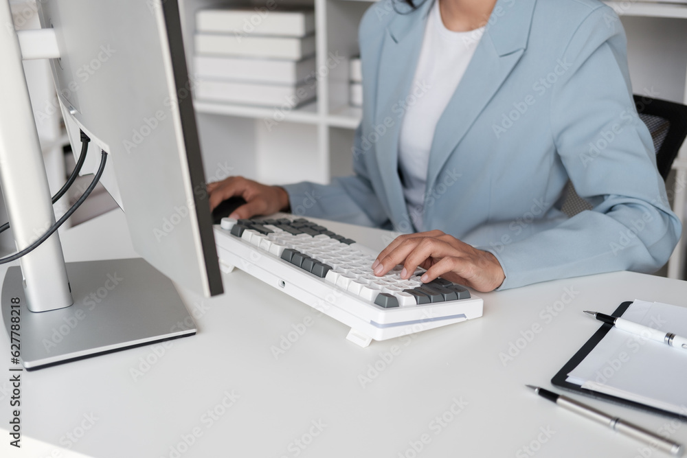 Aufkleber close up view of young businesswoman typing on keyboard computer while analyzing graph and trend in 