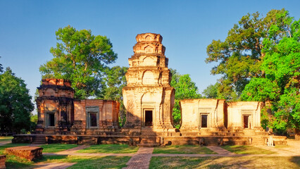 An image displaying Prasat Kravan, a small 10th-century temple comprising five reddish brick towers...