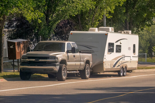 Calgary, Alberta, Canada. July 26, 2023. A Truck with a camper trailer RV on the route during summer.
