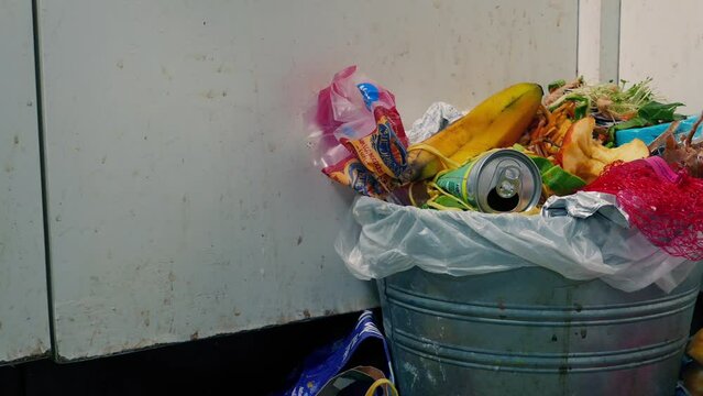 Passing Full Trash Can In Kitchen