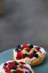 Two small homemade pavlova cakes, served in the garden. Selective focus.