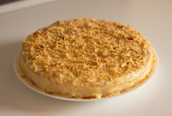 French cake Napoleon in a plate on the table. Confectionery product. Delicious torte with sweet...