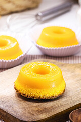 Quindim or Brisa do Lis, tasty dessert made with eggs in the background, Typical recipe from Brazil and Portugal