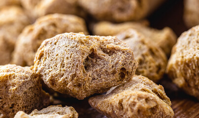 vegan food, coarse soy protein, also called soy meat, the protein textured in pieces inside a wooden bowl