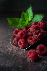 raspberries on a wooden background, raspberries on the shoulder blade with mint dark background 