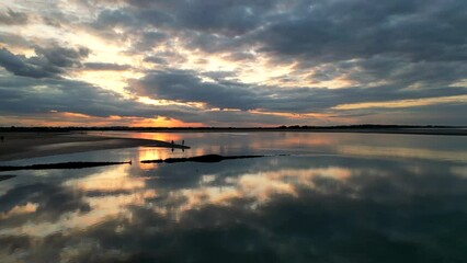 2 People enjoying sunset at the beach together