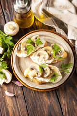 Toasted sandwich from baguettes bread with soft cheese and grilled mushrooms on wooden rustic  table. Homemade bruschetta with mushrooms. Copy space.