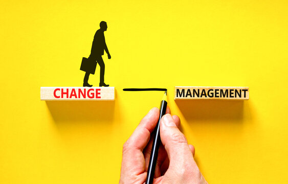 Change management symbol. Concept words Change management on beautiful wooden block. Beautiful yellow table yellow background. Businessman hand. Business change management concept. Copy space.