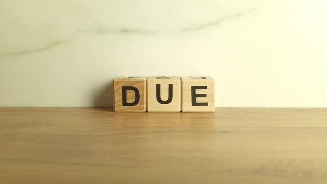 Word due from wooden blocks, business concept