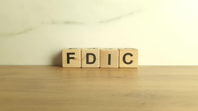 FDIC abbreviation from wooden blocks. Federal Deposit Insurance Corporation acronym. Finance and economy concept