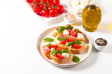 Tomato, basil and mozzarella cheese fresh made caprese bruschetta. Italian tapas, antipasti with...