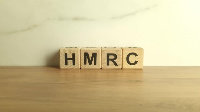 HMRC abbreviation from wooden blocks. Her Majestys Revenue and Customs UK tax authority concept