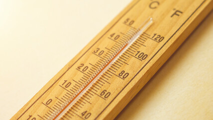 Heat waves and high temperature concept.Wooden thermometer showing extreme temperatures during...