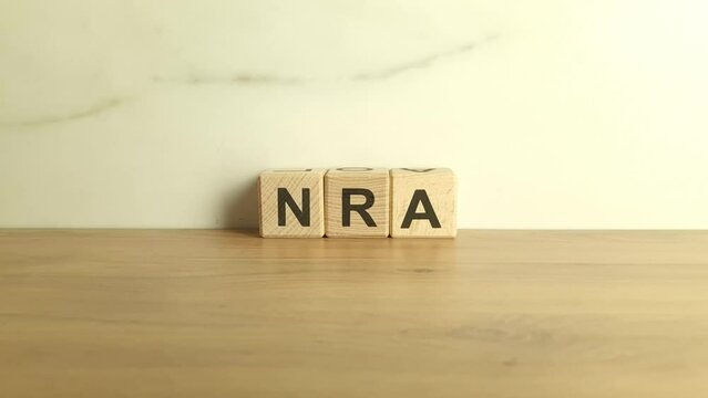 NRA abbreviation from wooden blocks. National Rifle Association acronym