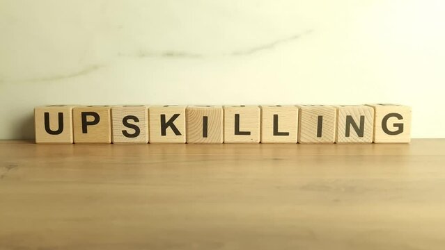 Word upskilling from wooden blocks. Business career, success and motivation concept