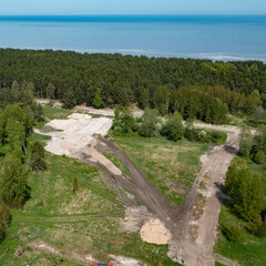 Fototapeta na wymiar Top drone view of construction site in forest. White sand. Nature of Jurmala. Baltic sea.