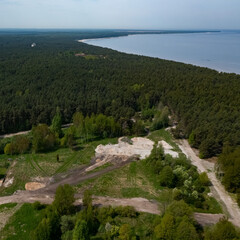 Fototapeta na wymiar Top drone view of construction site near forest. White sand. Nature of Jurmala. Baltic sea. Modern house.