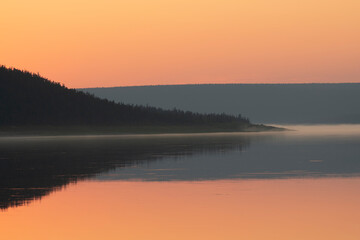 Obraz na płótnie Canvas Still river, sunset sky and reflections