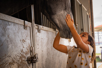 girl kissing horse tender image