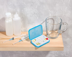 Medicine, health care. Pills to treat viral diseases, syringes to inject antibiotics, vitamins and nutritional supplements.