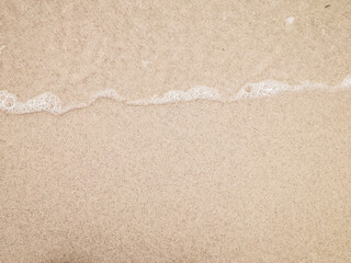Sea water on sandy beach sand - nature background.