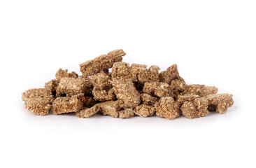 Pile of dried fish pieces for dogs and cats as snack, treat or reward. Heap of dehydrated flaky fish chunks to break. Healthy dog snack or health supplement rich on protein, omega 3. Selective focus.
