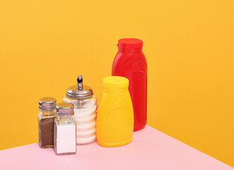Mustard and ketchup dispensers, salt, sugar, black pepper. Dinner party.