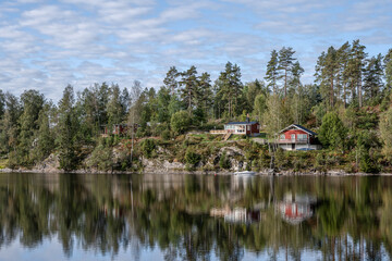 Fototapeta na wymiar Lake Ragnerudssjoen in Dalsland Sweden beautiful nature forest pinetree swedish houses