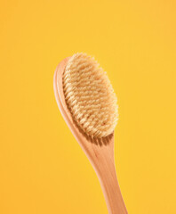 Plastic free and body care concept. Natural body brush in the shower. Thick bristles for anticellulite massage.
