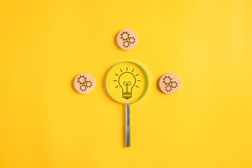 Light bulb and setting icons with magnifying glass for business strategy planning management,...