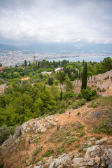 Obraz premium Old ancient ruins of historic building, wall and a tree trunk in foreground. Part of Alanya castle, Turkey. 
