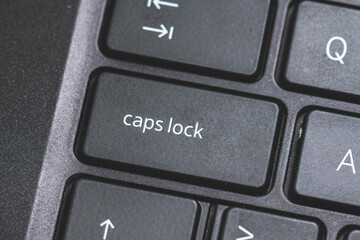 Caps Lock key on a black laptop keyboard.