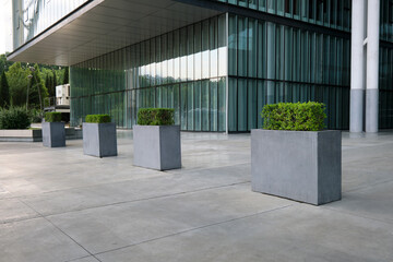 Decorative concrete pedestals with flowers to restrict the entry of cars into the territory.